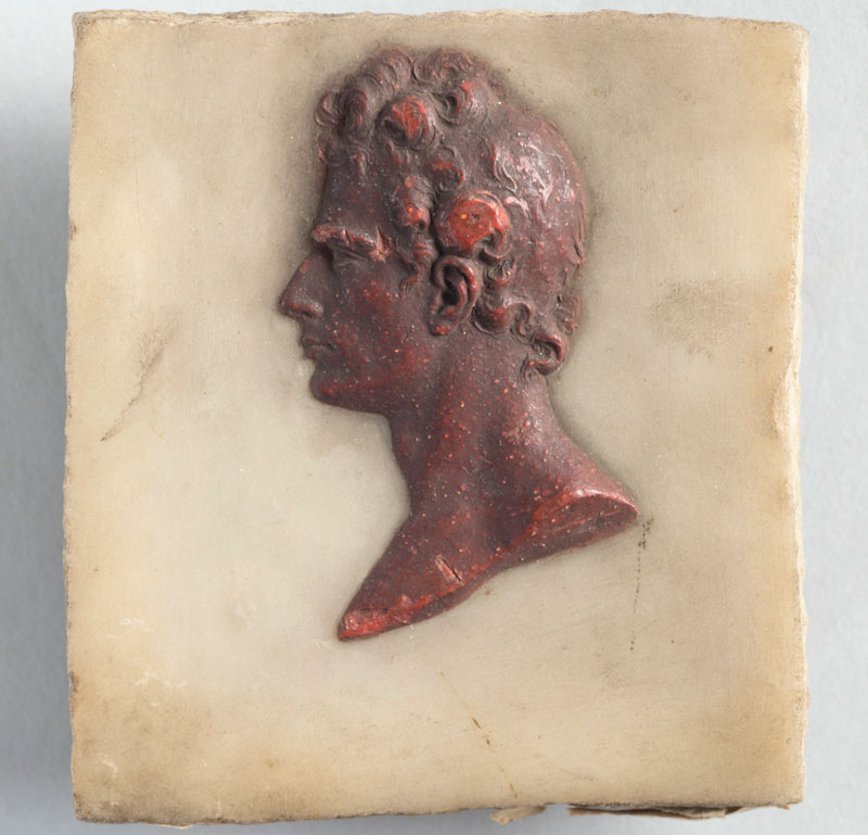 relief sculpture of Gibson's head