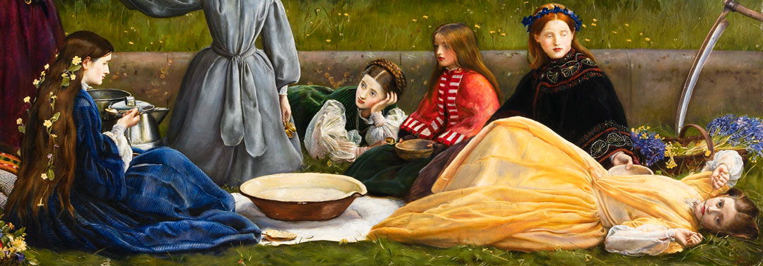 Women in long dresses sitting and lying around a picnic blanket