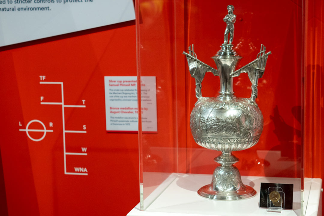 trophy and medallion in museum display by Plimsoll line on wall