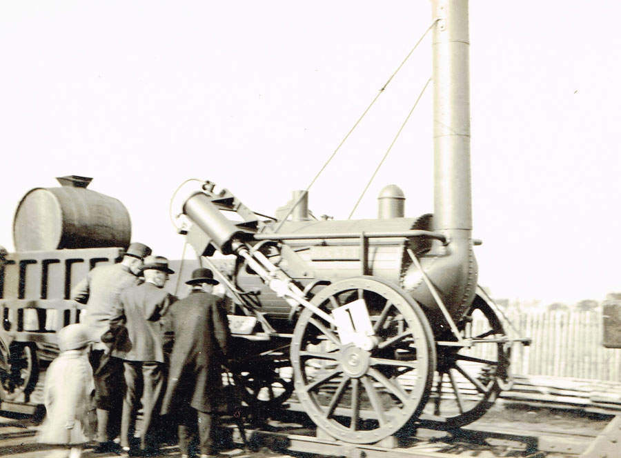 people looking at the Rocket, replica railway locomotive