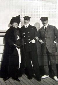 Captain Rostron with two smartly dressed passengers