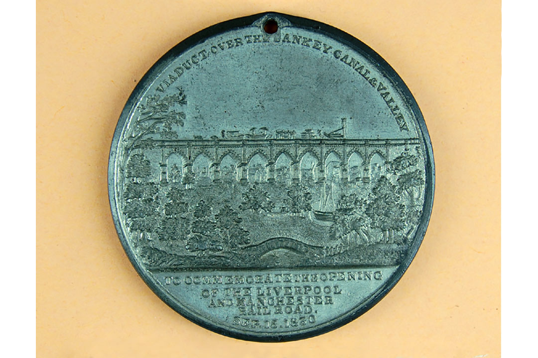 medal with image of train on a viaduct