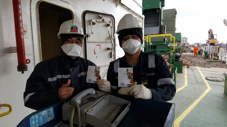 seafarers wearing protective masks