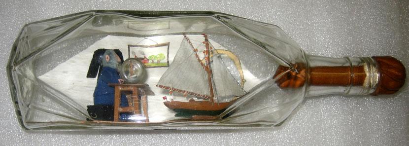 bottle containing a model of a man making ships in bottles